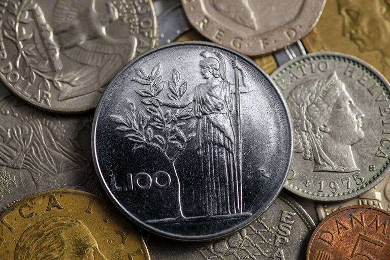 Monete da 500 Lire italiane su un tavolo, simbolo di un possibile tesoro nascosto.